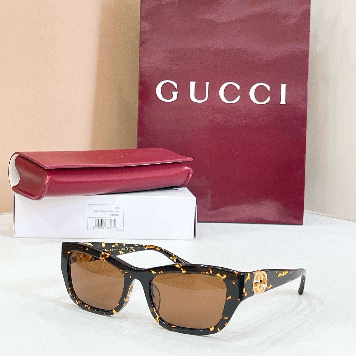 Tortoiseshell rectangular sunglasses with brown lenses and gold logo detail