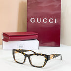 Gucci eyeglasses frame, black tortoise with gold GG logo at temple