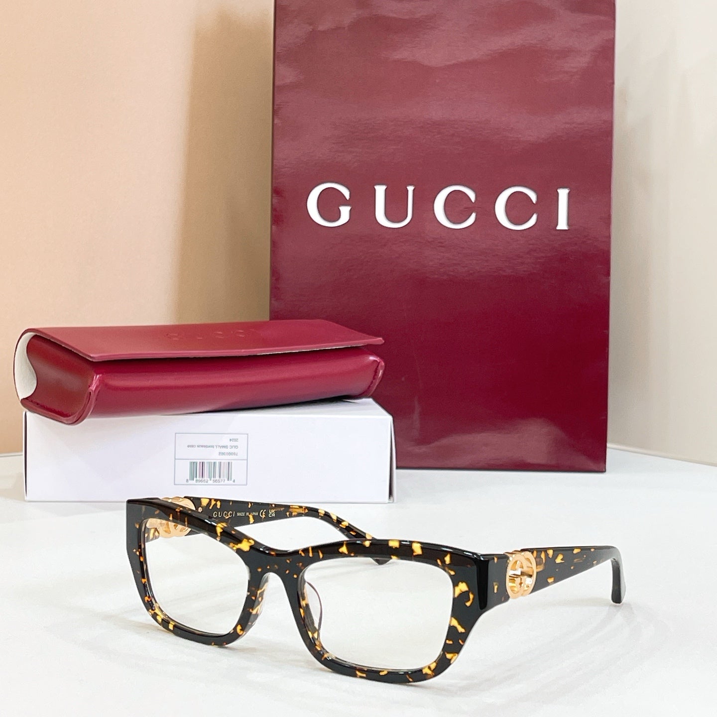 Gucci eyeglasses frame, black tortoise with gold GG logo at temple
