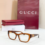 Gucci eyeglasses frame, brown tortoise with gold GG logo at temple