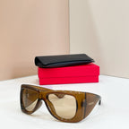 YSL sunglasses with dark tortoise frames and amber lenses, with black case