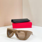 YSL sunglasses with tan frames and tinted lenses, with black case