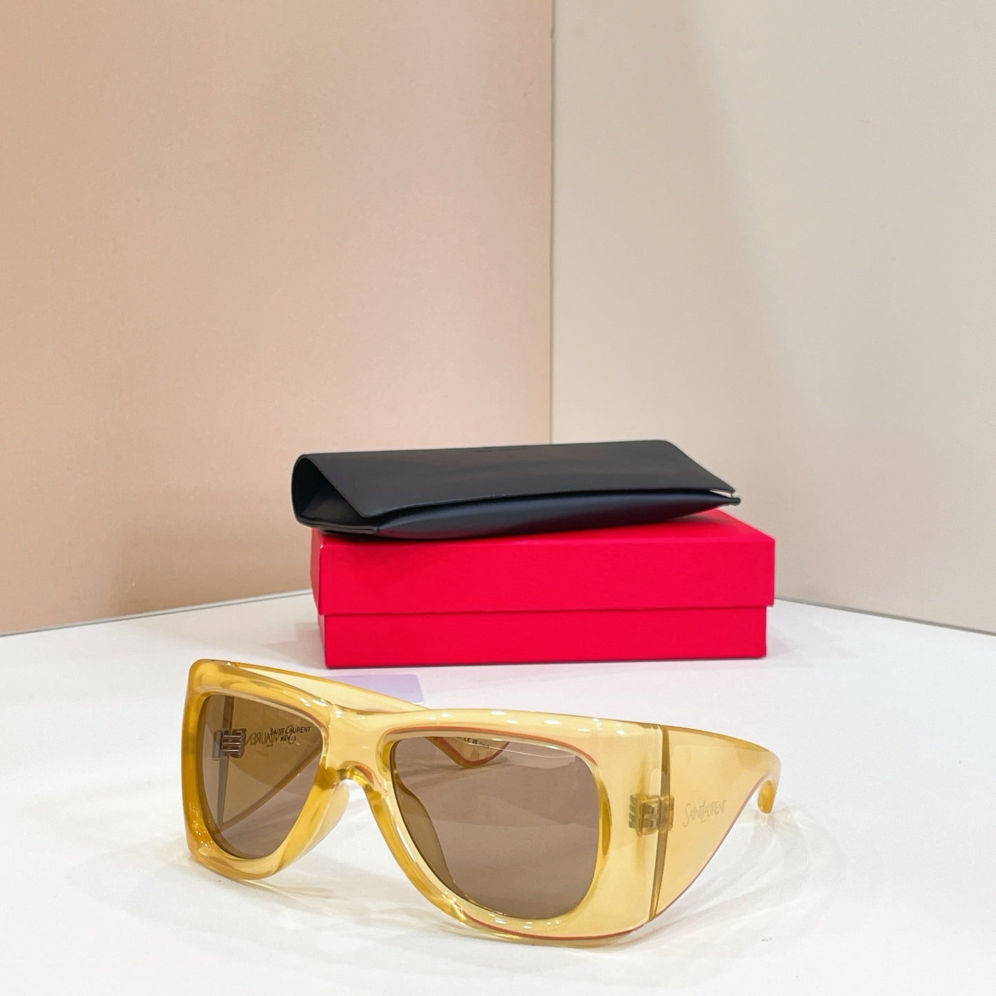 YSL sunglasses with gold frames and tinted lenses, with black case