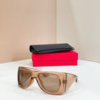 YSL sunglasses with light brown frames and tinted lenses, with black case