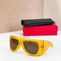 Yellow oversized sunglasses, dark lenses, glossy frame, YSL