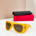 Yellow oversized sunglasses, dark lenses, glossy frame, YSL
