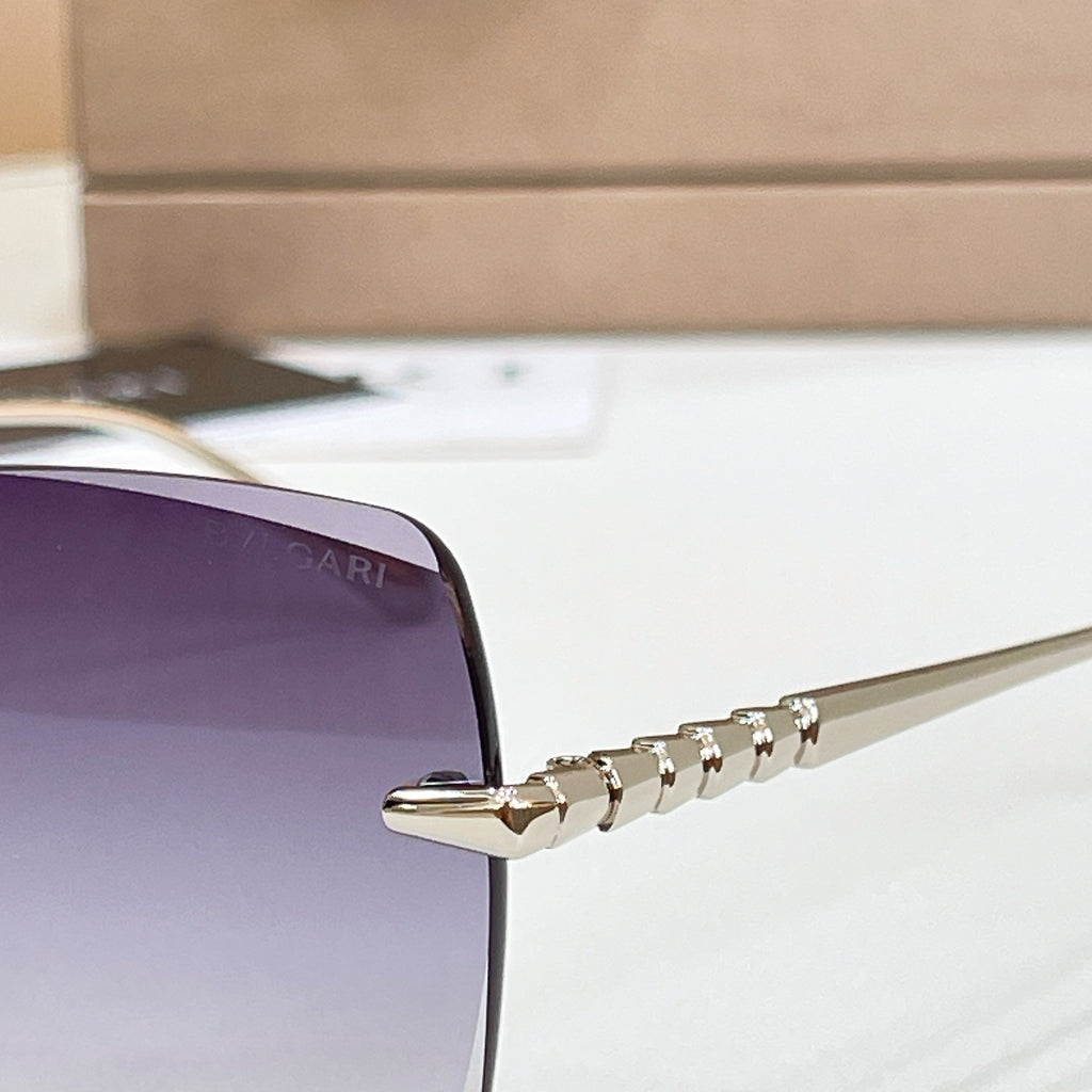 Bvlgari sunglass temple with gold-tone engraved detail and metal hinge