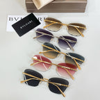 Assorted sunglasses with gold-tone frames and mixed dark, purple, and red lens tints