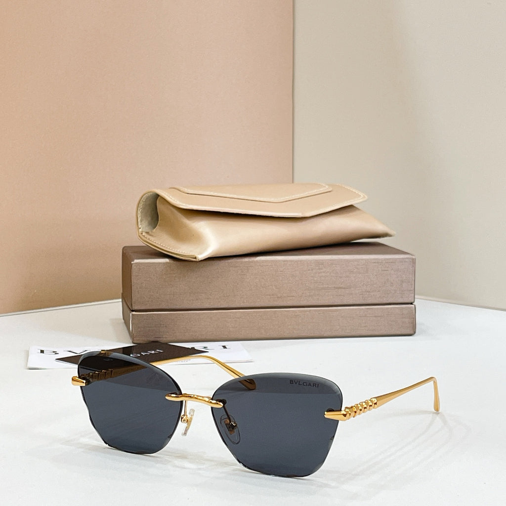 Gold-tone sunglasses with dark blue tinted lenses and thin rectangular frames