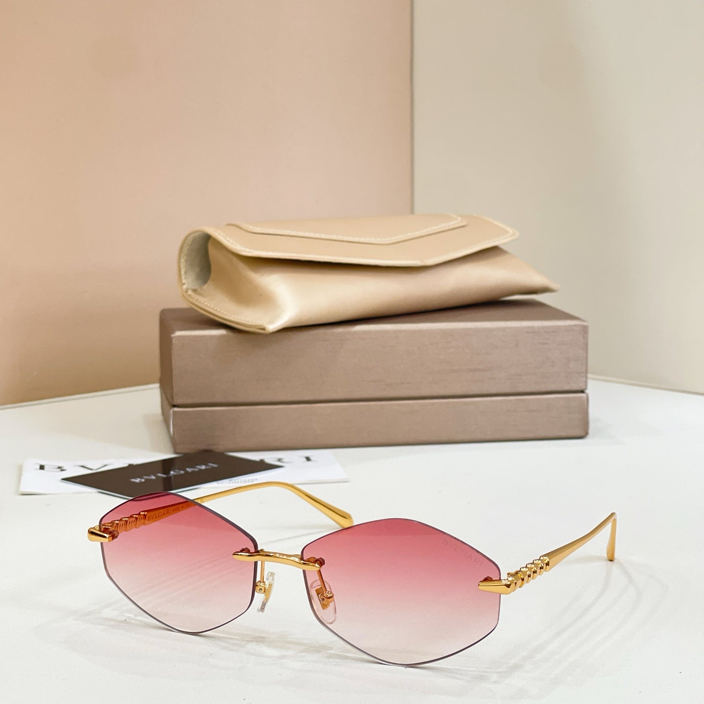 Bvlgari sunglasses with gold metal frame and red tinted round lenses