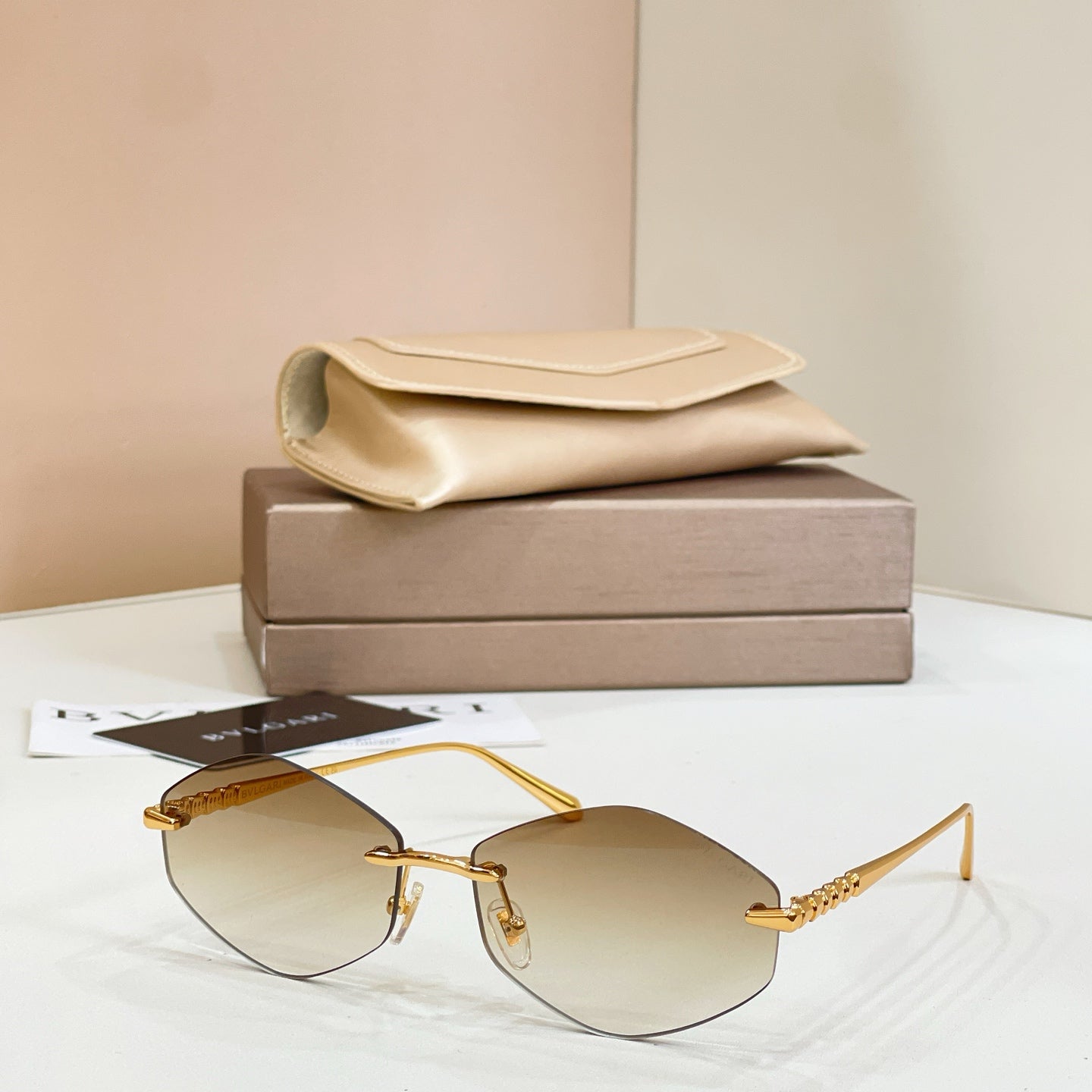 Bvlgari sunglasses with gold metal frame and amber tinted round lenses