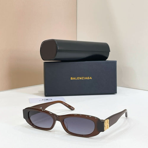Balenciaga tortoiseshell oval sunglasses with gold-tone emblem and dark lenses