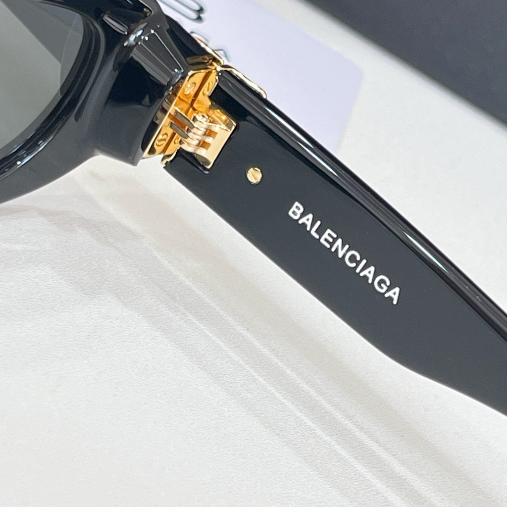 Balenciaga black sunglasses temple with BALENCIAGA text and gold-tone hinge