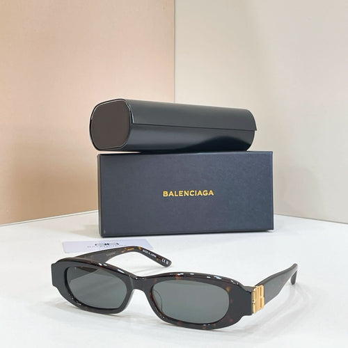 Balenciaga black oval sunglasses with gold-tone hinge detail and dark lenses