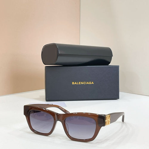 Sunglasses with brown frames and tinted lenses, gold logo detail at temple.