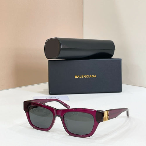Sunglasses with burgundy frames and dark lenses, gold logo detail at temple.