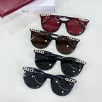 Gucci sunglasses shown together with red, brown, black, and navy frames