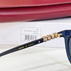 Gucci sunglasses, blue frames with gold-tone chain detail on temple