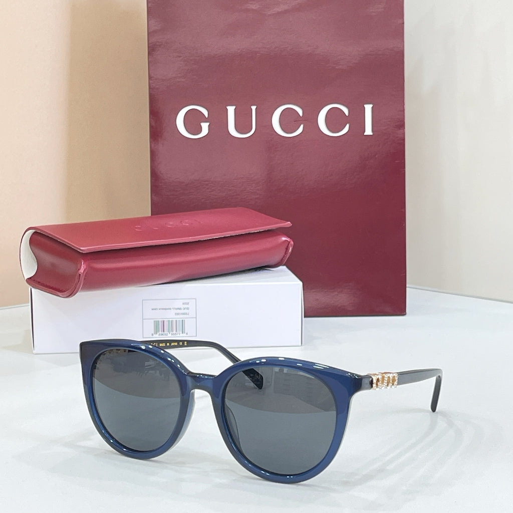 Gucci sunglasses with blue frames and dark lenses