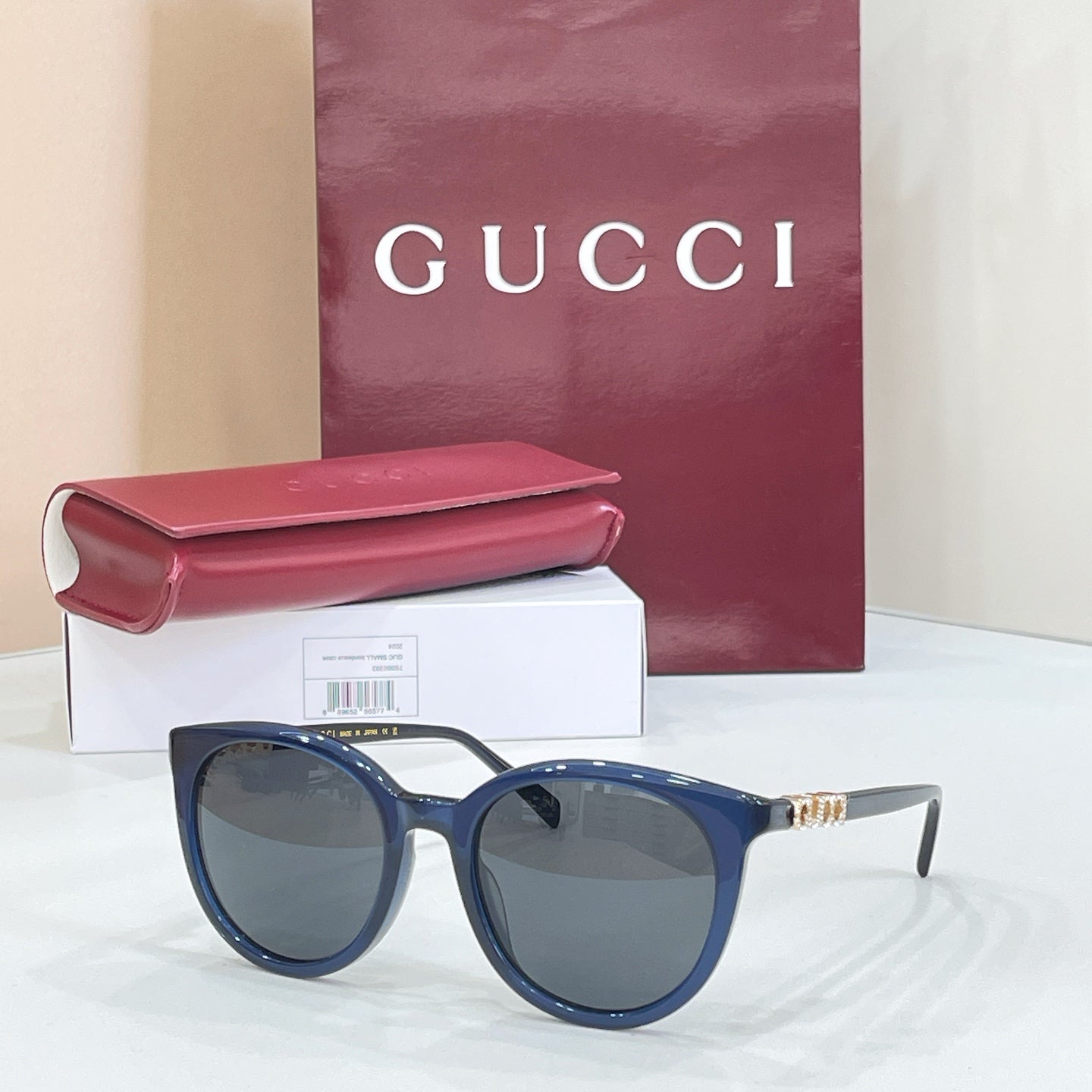 Gucci sunglasses with blue frames and dark lenses