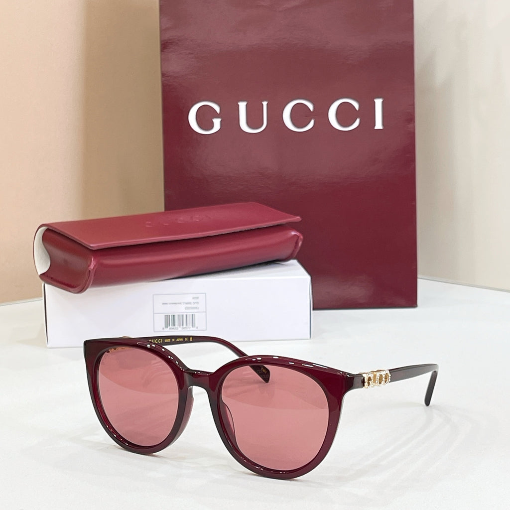 Gucci sunglasses with burgundy frames and rose-tinted lenses