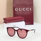 Gucci sunglasses with burgundy frames and rose-tinted lenses