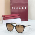 Gucci sunglasses with tortoiseshell frames and amber lenses