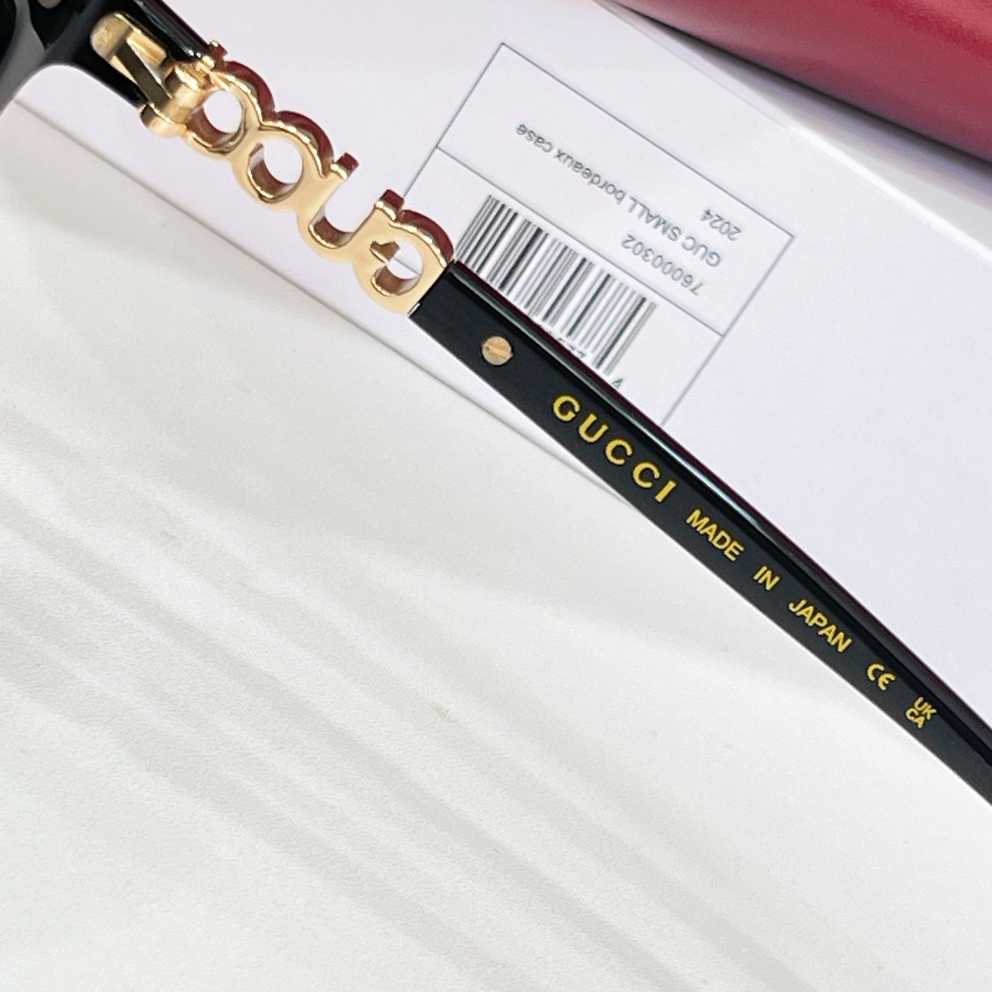 Gucci glasses close-up: black temple with gold logo and Made in Japan text