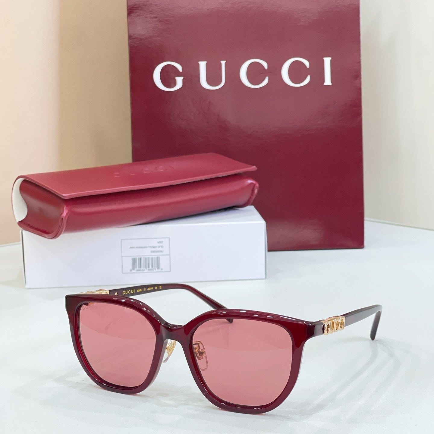 Gucci glasses with burgundy frames and pink gradient lenses