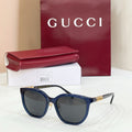Gucci glasses with dark blue frames and dark gray lenses
