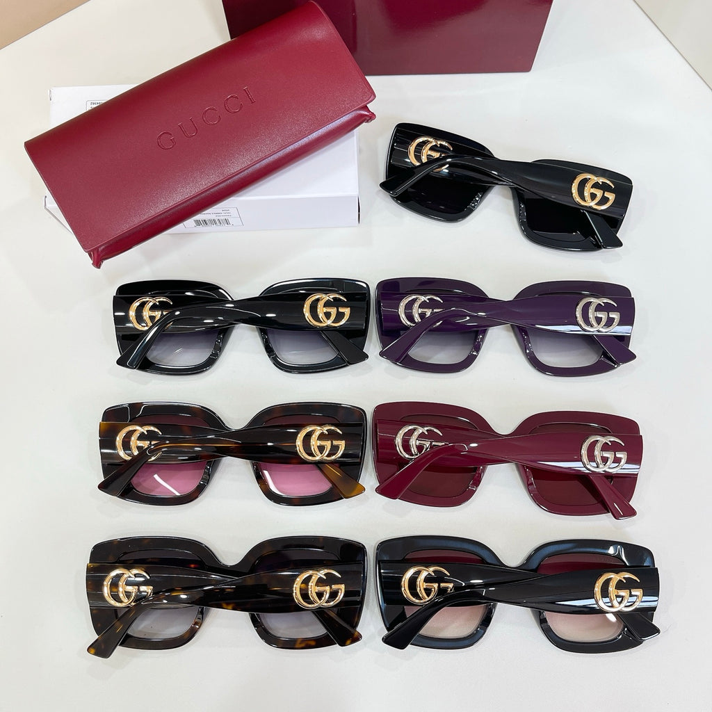 Gucci sunglasses assortment with red case, featuring several colored tinted frames.