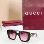 Gucci sunglasses with tortoiseshell frames and pink-tinted lenses, gold GG logo temple.