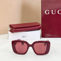 Burgundy oversized sunglasses with tinted lenses, on box and case
