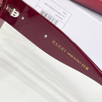 Burgundy sunglass frame arm with 'Gucci Made in Italy' lettering