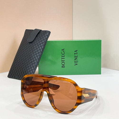 Sunglasses with tortoiseshell frames, amber lenses, and black textured case