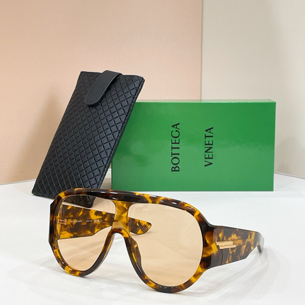 Sunglasses with amber tortoiseshell frames and clear amber lenses, with black case