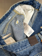 Dior pants, open waistband showing care tags inside light blue denim pockets