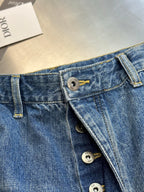 Dior pants, denim waistband close-up with button fly and brand hardware