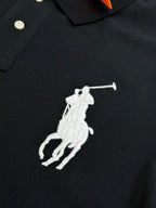 Dark navy polo shirt with large white rider logo on front