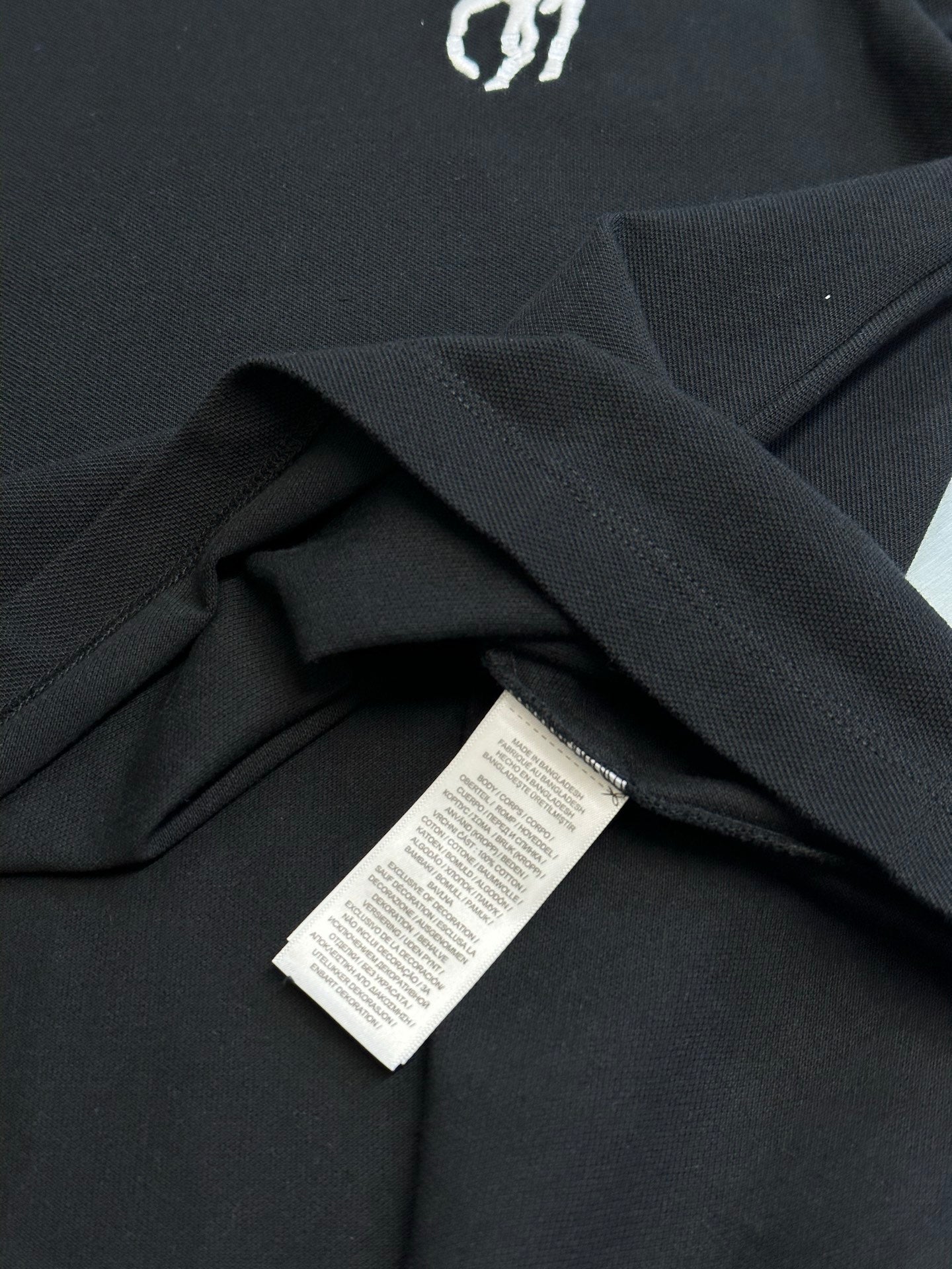 Dark navy polo shirt hem with care label inside