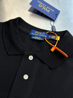 Dark navy polo shirt collar with 3-button placket and brand tag