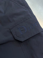 Navy cargo shorts close-up of embroidered Dior logo on cargo pocket