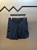 Navy cargo shorts with button fly and multi-pocket design, hanging on a hanger