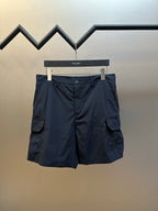 Navy cargo shorts with button fly and multi-pocket design, hanging on a hanger