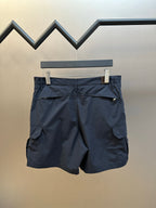 Navy cargo shorts back view with flap pockets and pleated waistband