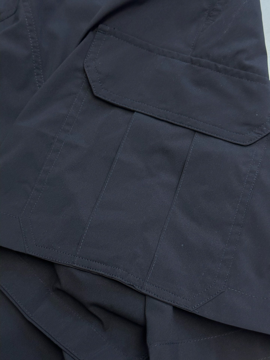 Navy cargo shorts with stitched flap pocket and side seam details