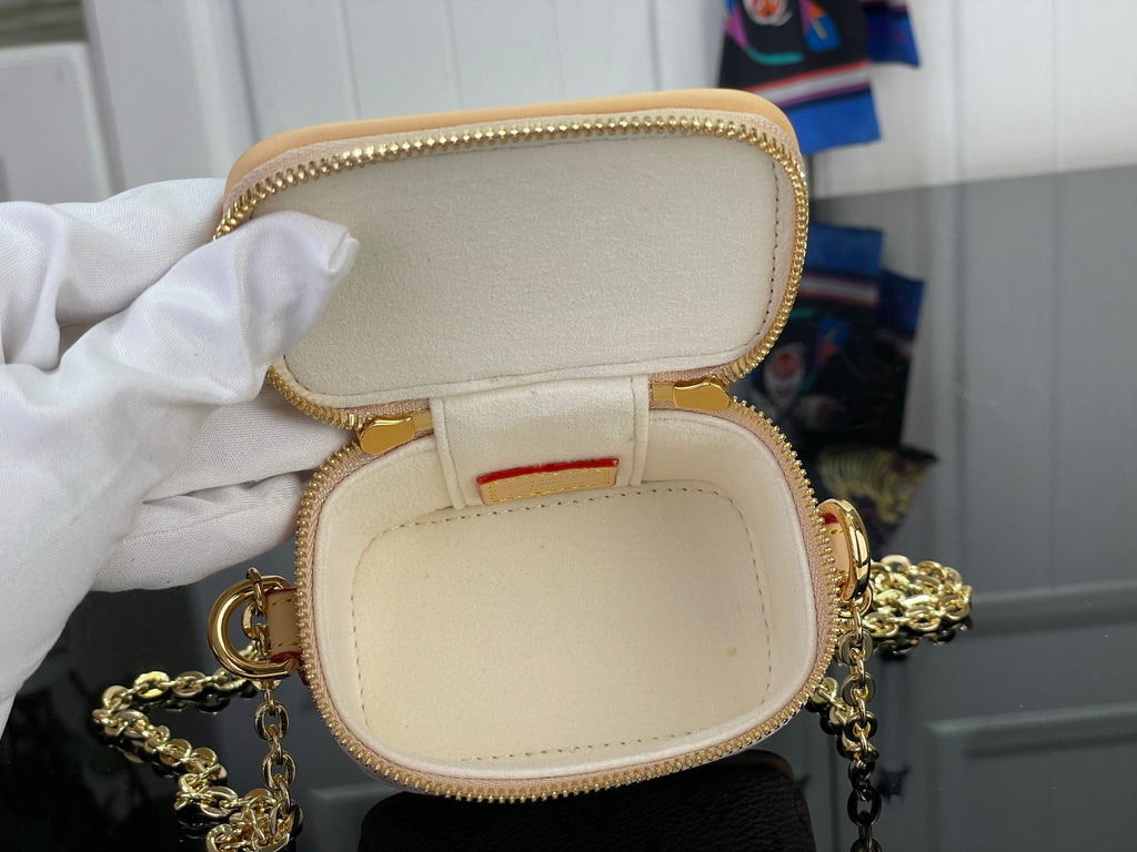 Mini monogram bag opened to show cream interior and gold chain strap