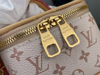 Monogram mini bag zipper pulls with gold hardware on white canvas