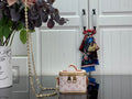 Small monogram crossbody bag with gold chain strap, top handle, and zipper closure