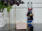 Mini monogram bag with rounded flap front, gold chain strap, and top handle